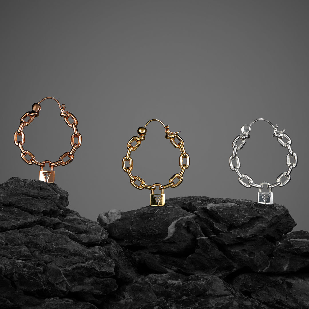 Unique ‘90s-style earring hoops with chain-link details and a lock pendant, showcasing a Tawapa sigil cutout for a bold look.