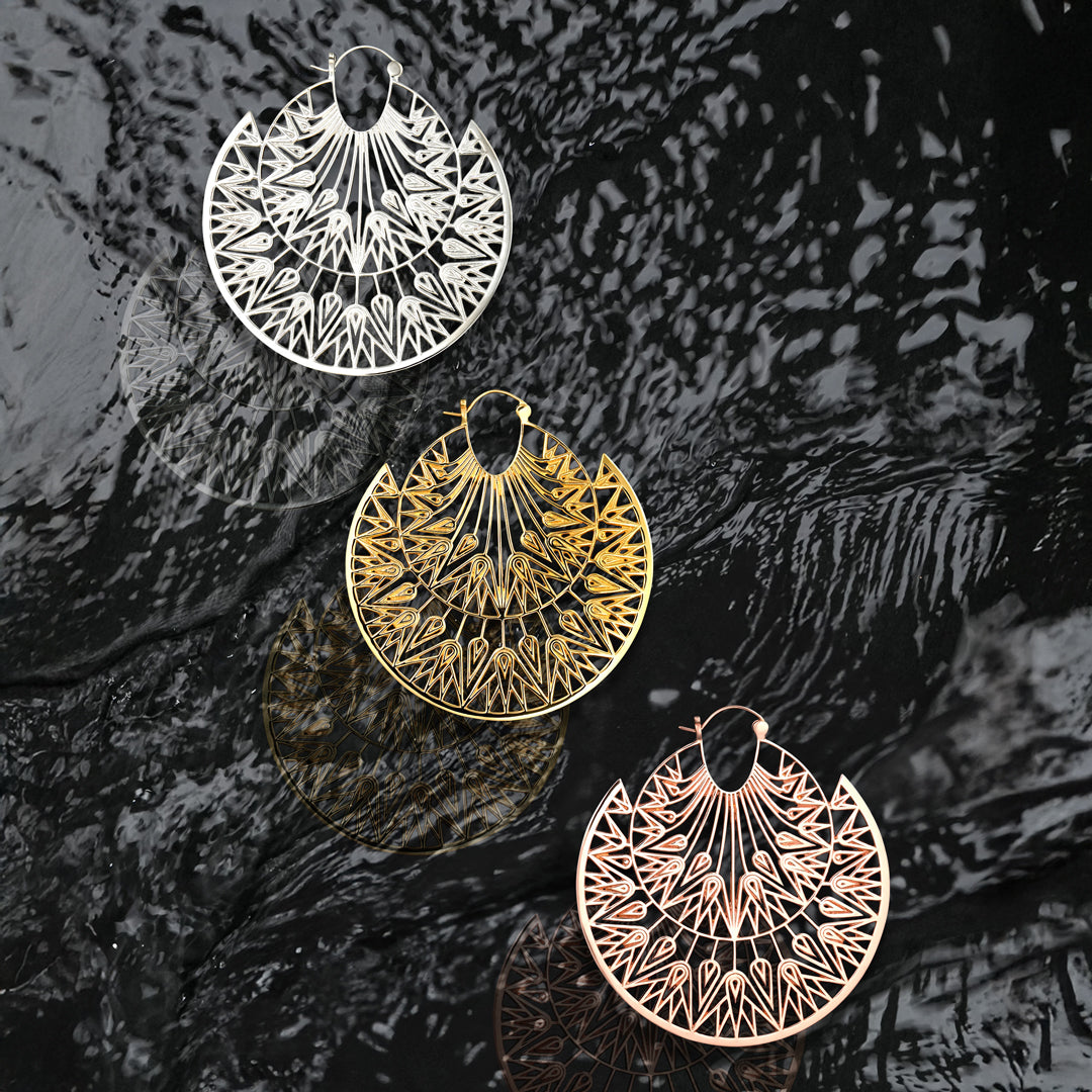 Bold gold hoop earrings inspired by papyrus leaves and sunlit glamour