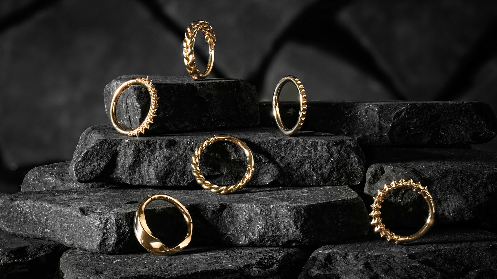 The City Series Collection of 14k Gold Clickers styled on tiered rocks