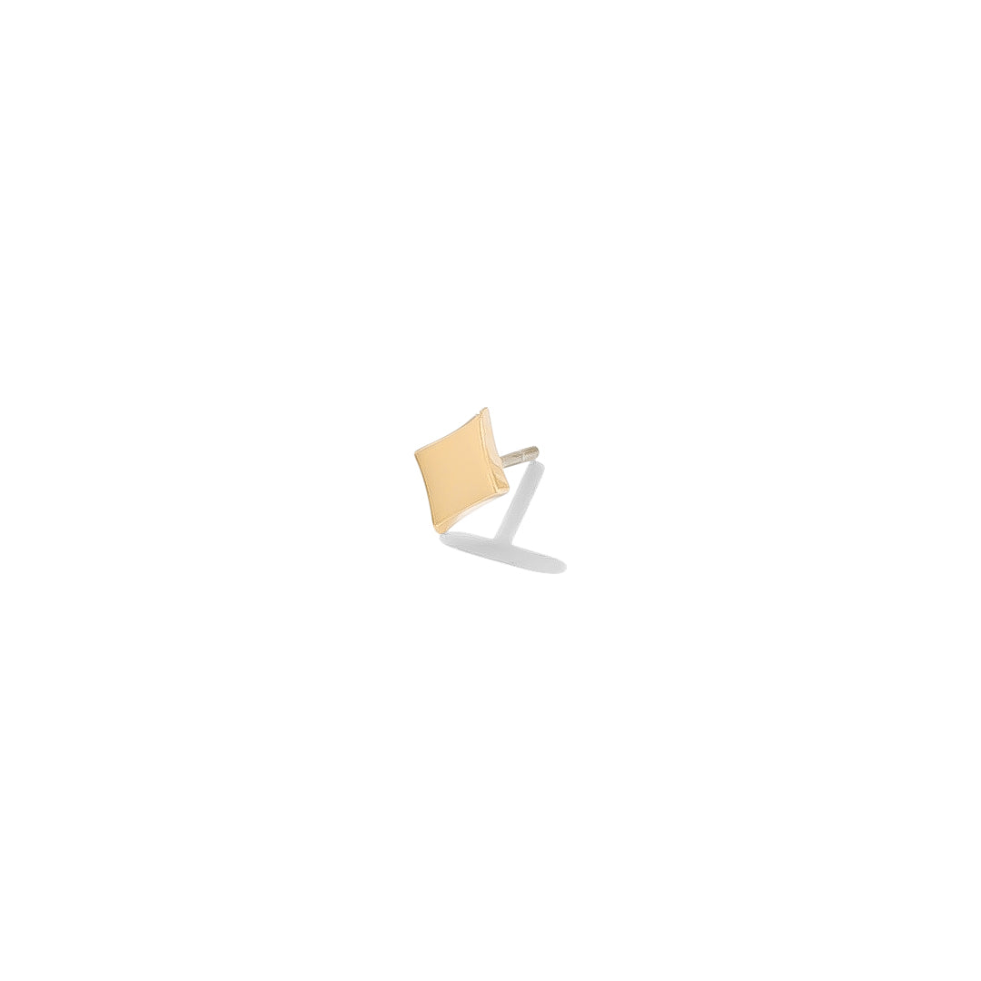 Gold diamond-shaped piercing jewelry symbolizing wealth