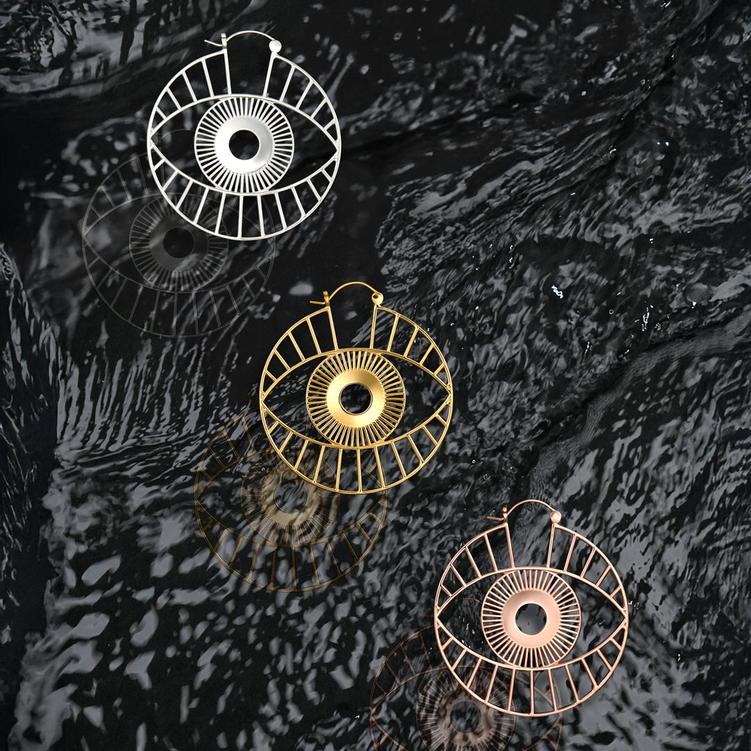 Geometric cutout hoop earrings with surreal eye detailing