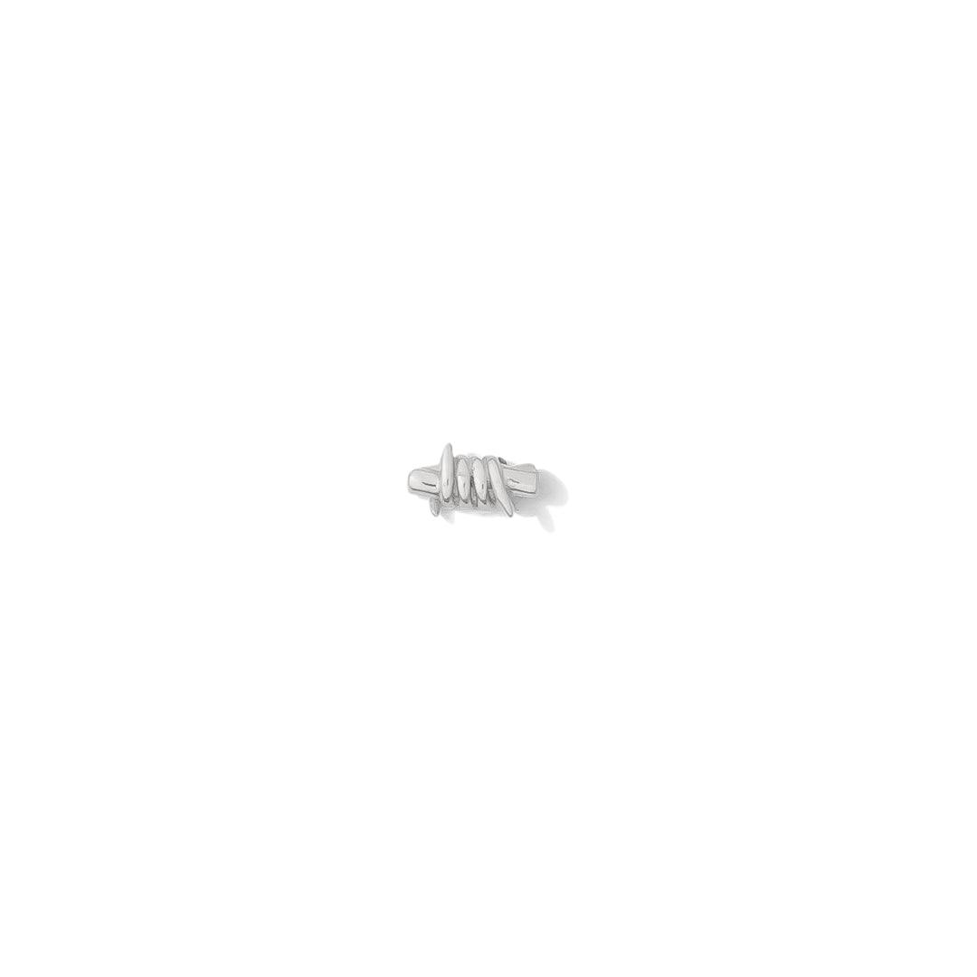 14k white gold barb wire style threadless end on white background flat lay tawapa
