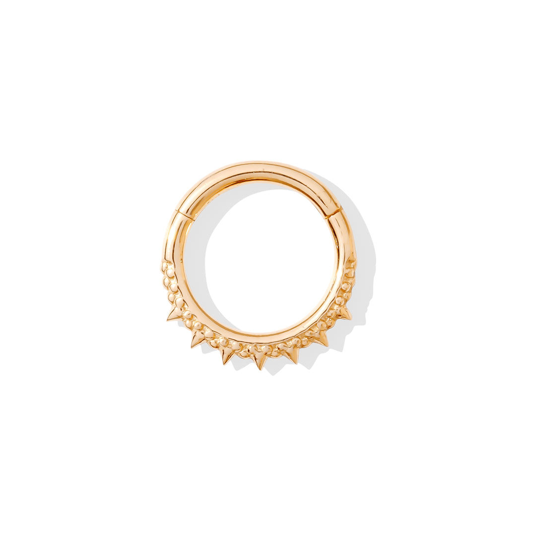 Luxurious gold septum clicker with spiked and ornamental features.