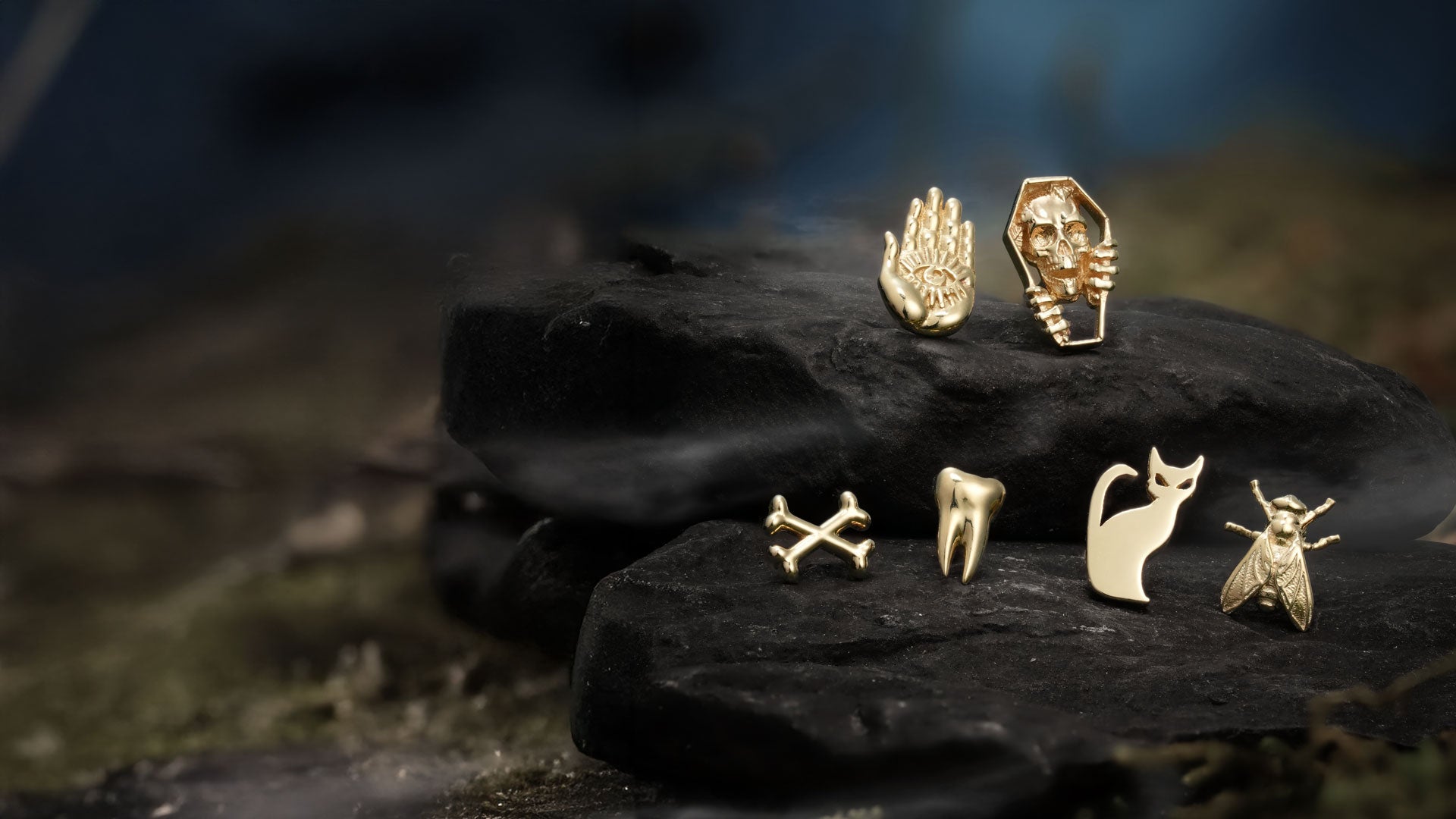 Halloween Gold threadless ends on a dark stone surface with a blurred natural background