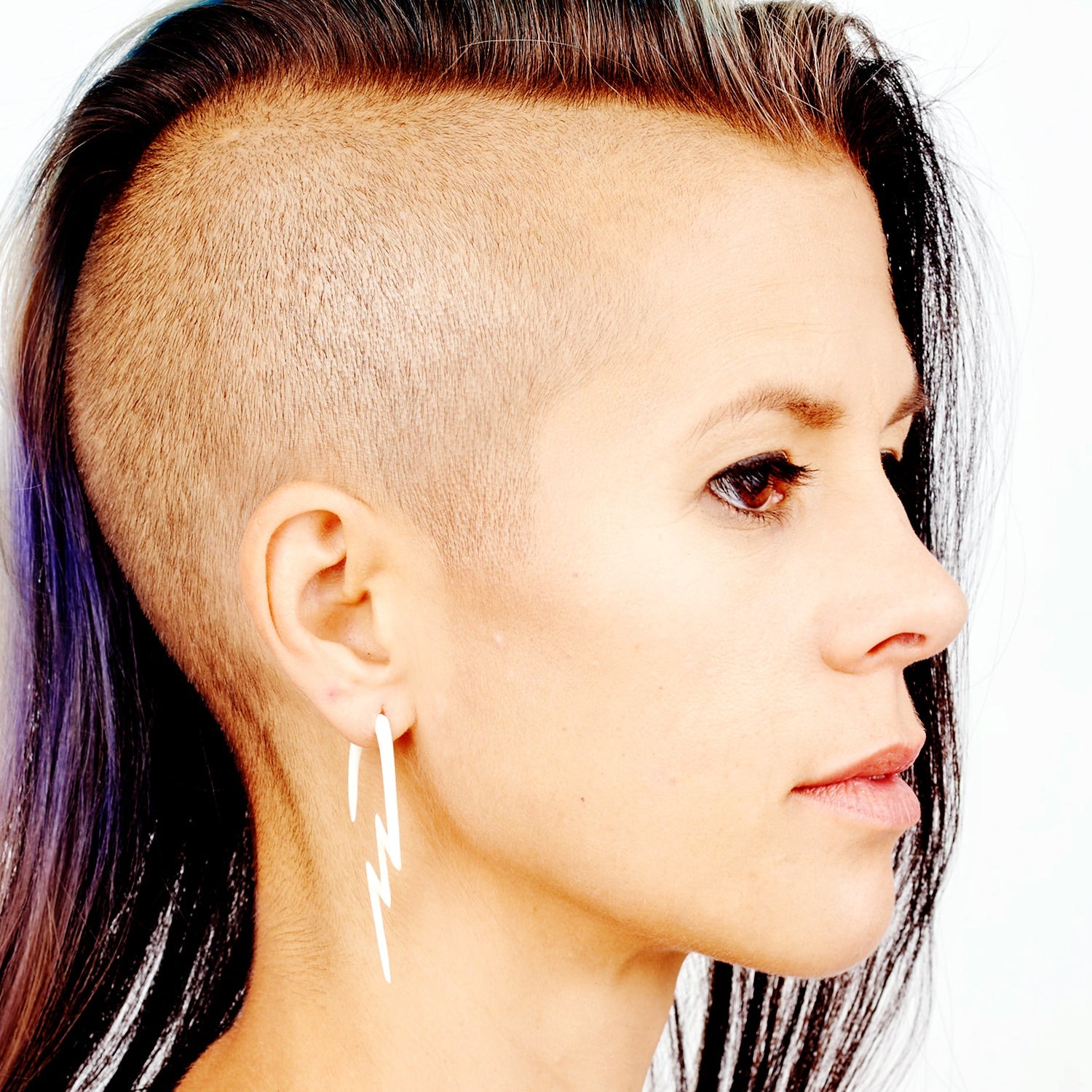 Hand-carved bone Lightning Bolt design in organic material for stretched lobes shown on model TAWAPA